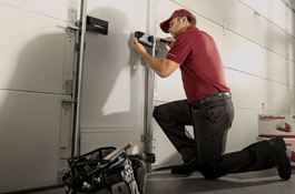 garage door technician installing garage door opener