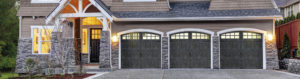 three garage doors with windows and arches