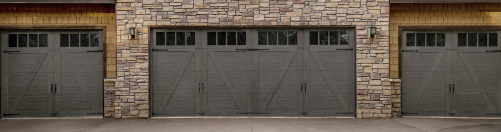 double garage doors with windows on stone house