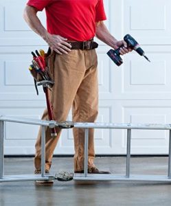 garage door technician preparing to install new garage door panels